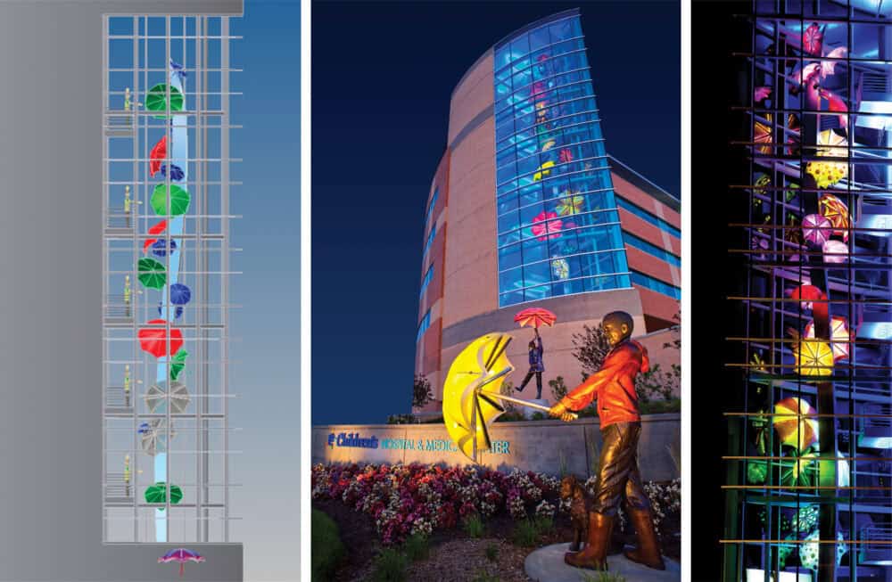 Colorful umbrellas decorate building and statue.