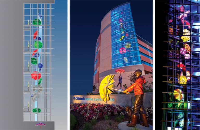 Colorful umbrellas decorate building and statue.